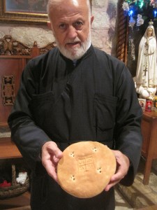 An Orthodox priest showing me the qurban (Eucharist) at an ancient church in Al-Salt, Jordan.